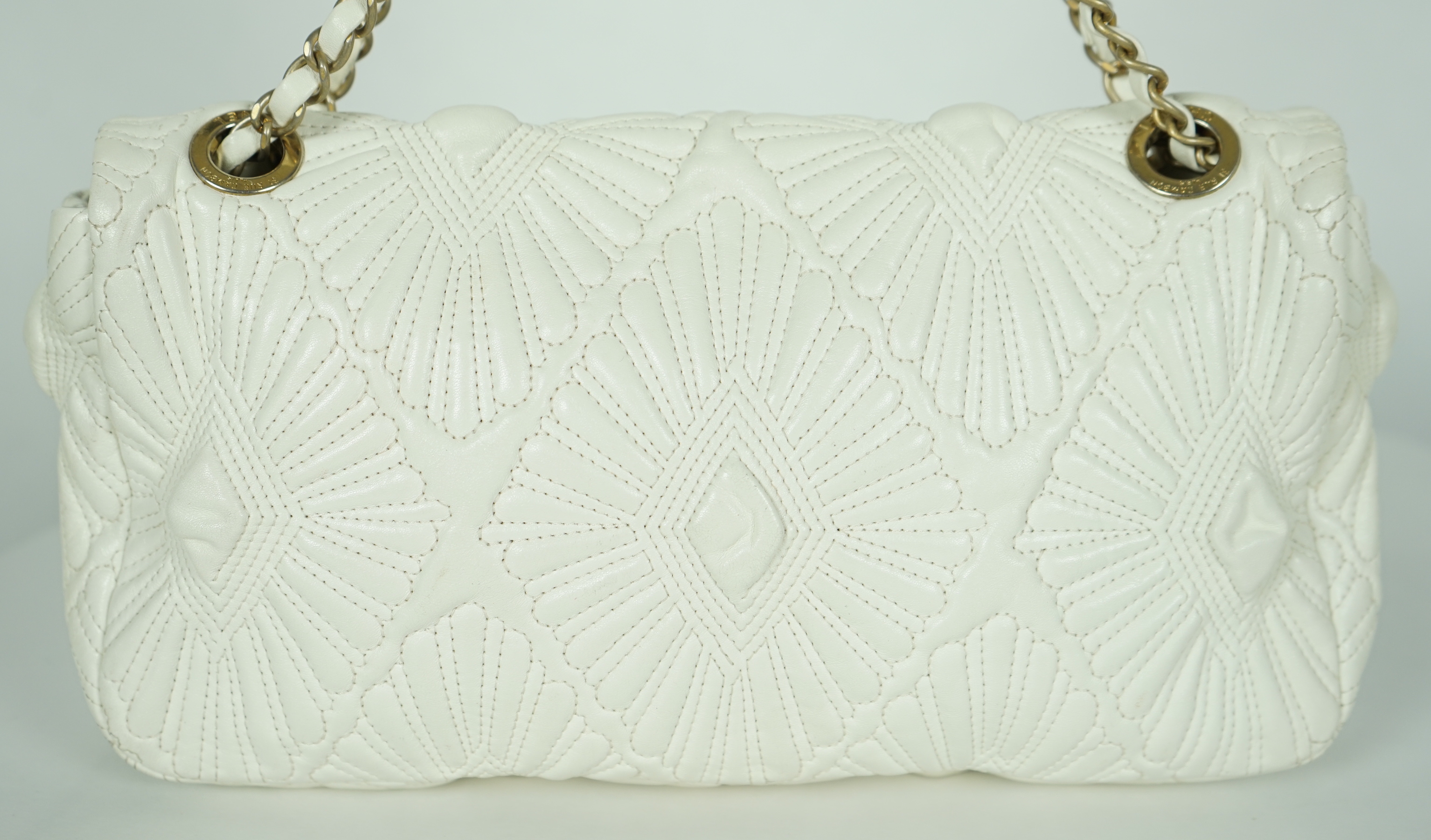 A white quilted Chanel shoulder bag, with maker’s dust bag, height 17cm, overall height 37cm, width 30cm, depth 7cm, Please note this lot attracts an additional import tax of 20% on the hammer price